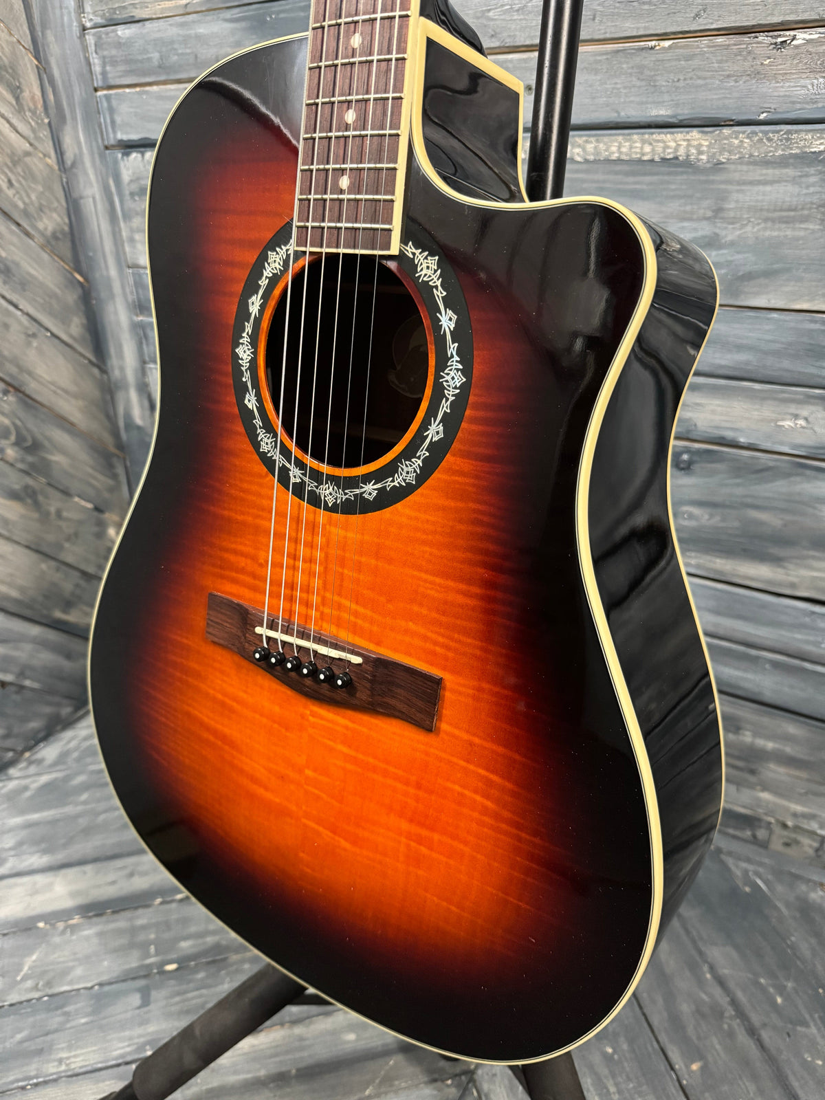 Acoustic guitar with a sunburst finish on a wooden surface