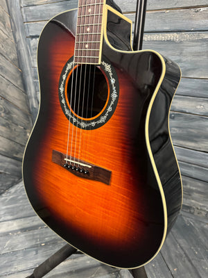Acoustic guitar with a sunburst finish on a wooden surface