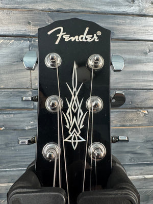 Fender guitar headstock with logo against a wooden background
