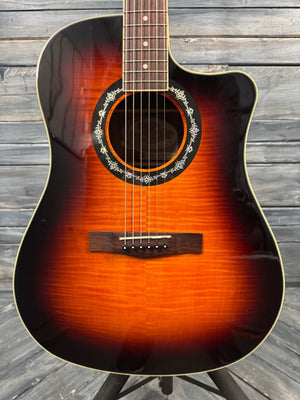 Acoustic guitar with a sunburst finish on a wooden surface