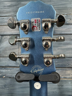 Close-up of a guitar's tuning pegs and headstock with a wooden background