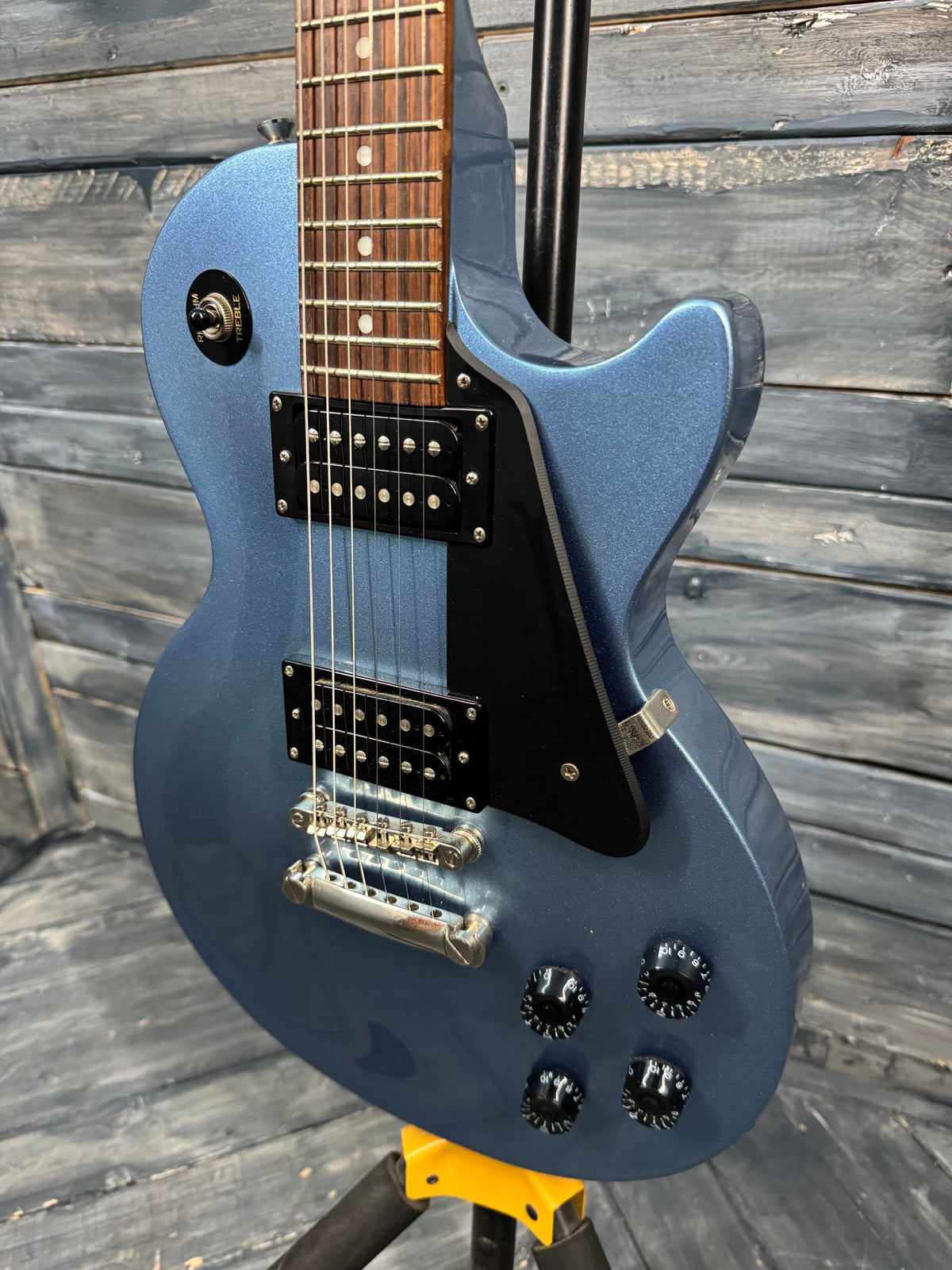 Blue electric guitar on a wooden surface