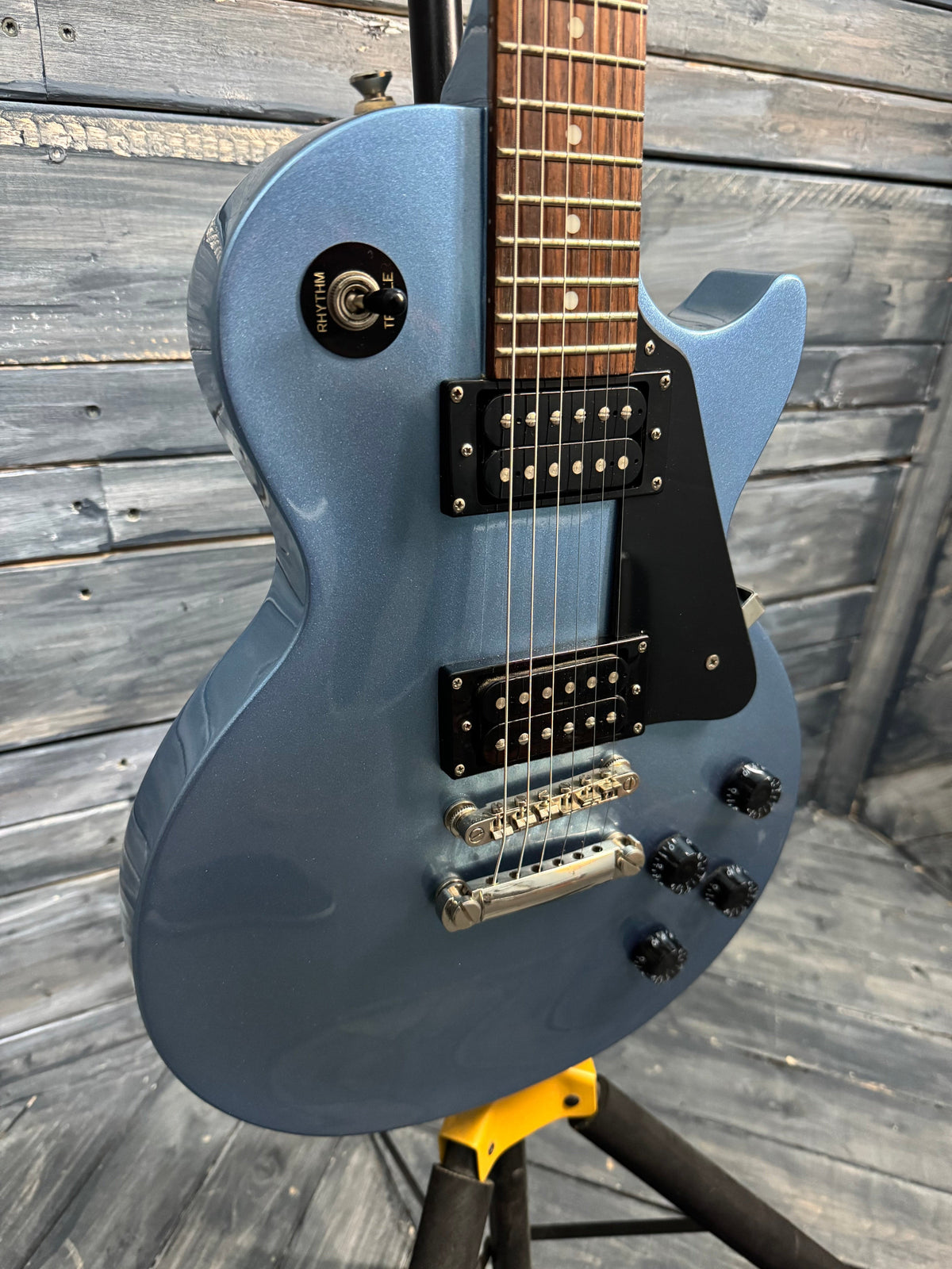 Blue electric guitar on a wooden surface