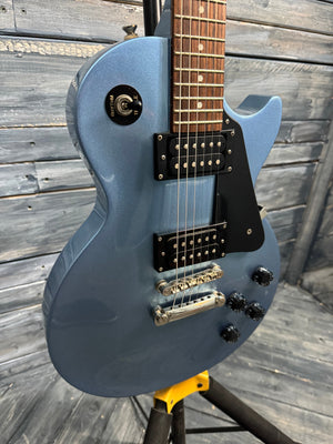 Blue electric guitar on a wooden surface