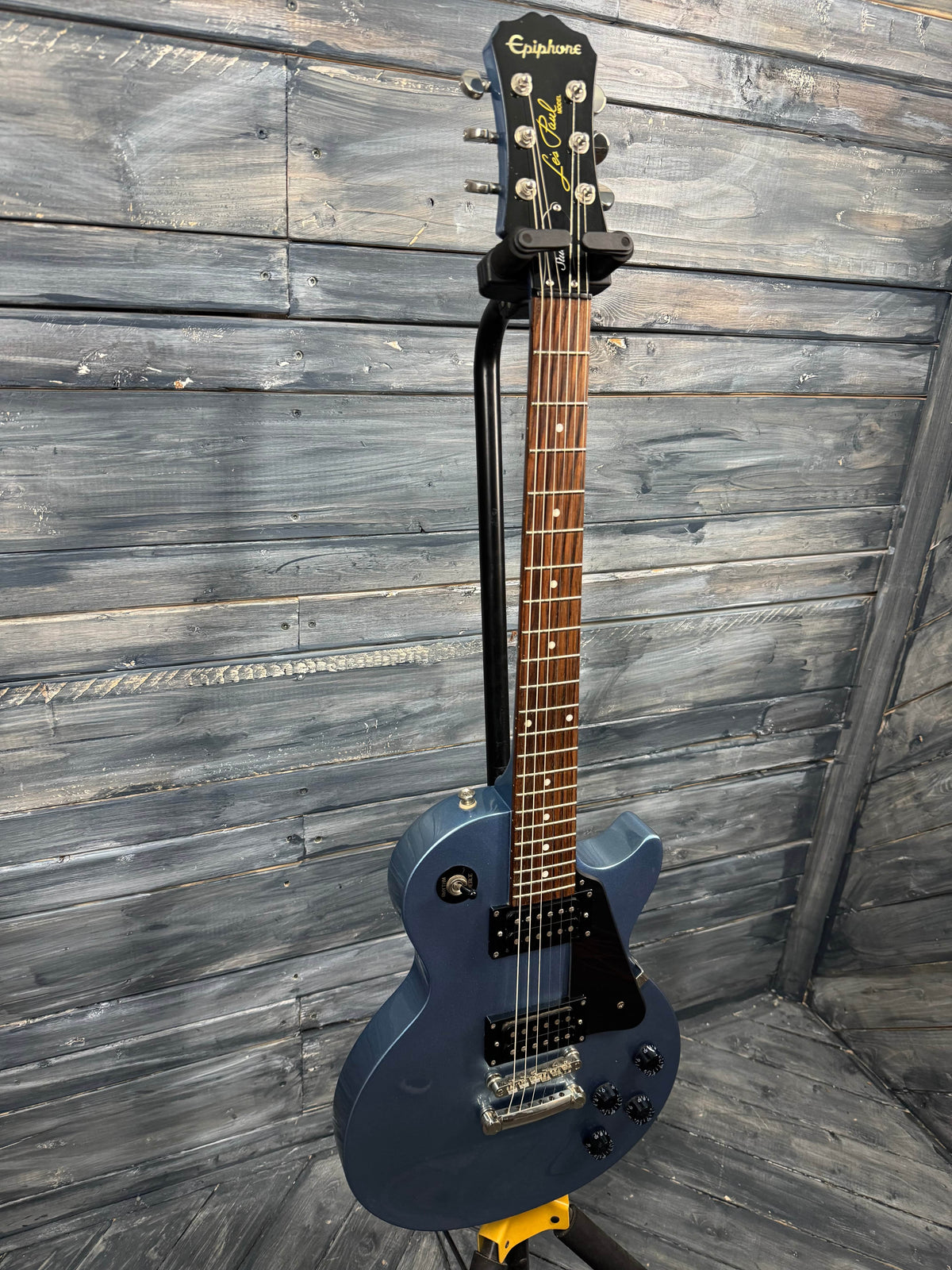 Blue electric guitar on a wooden floor