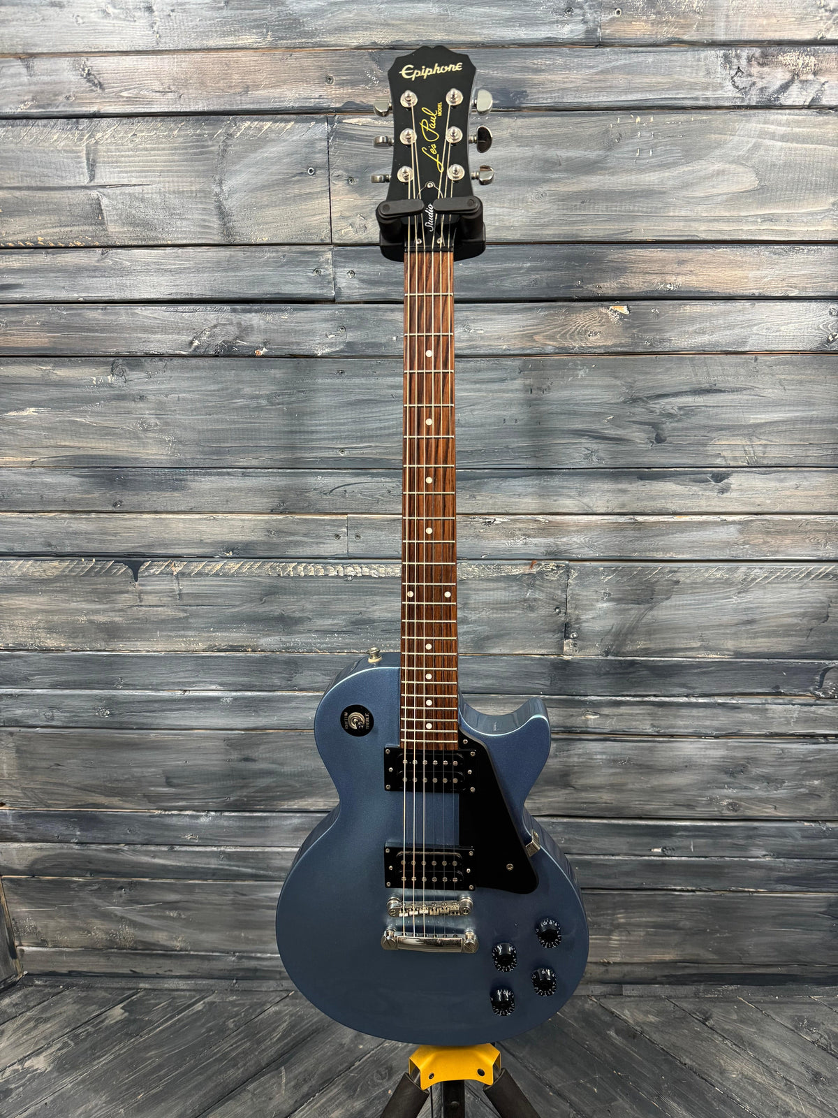 Blue electric guitar on a wooden background