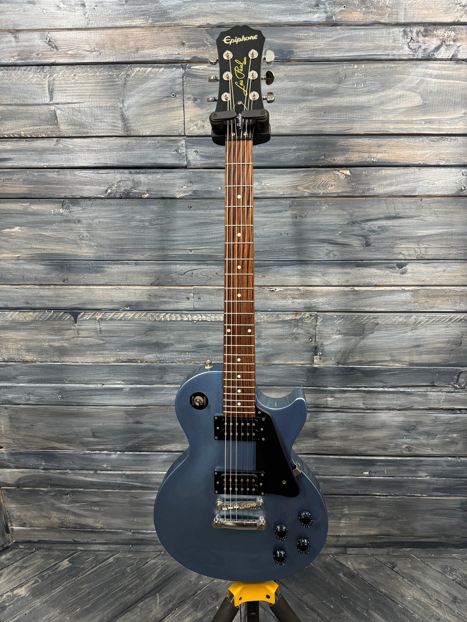 Blue electric guitar on a wooden background