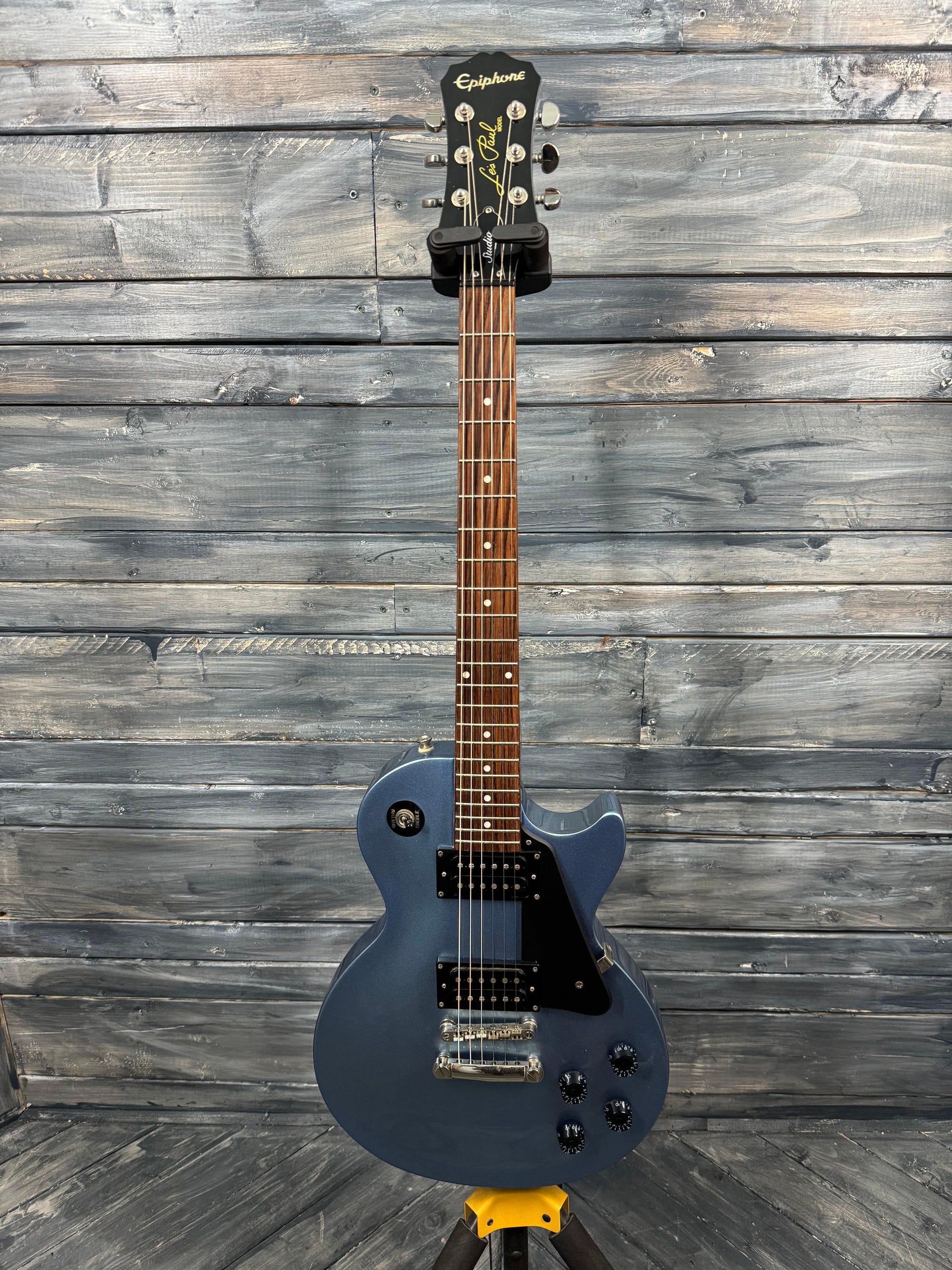 Blue electric guitar on a wooden background