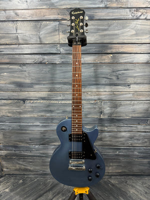 Blue electric guitar on a wooden background