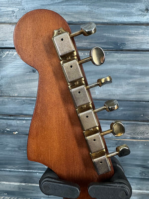 Close-up of a guitar's tuning pegs against a wooden background
