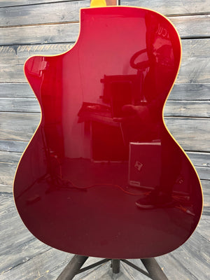 Red electric guitar on a wooden surface