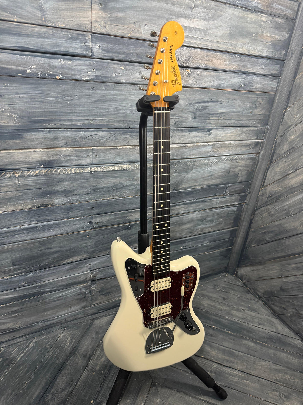 White electric guitar on a wooden floor