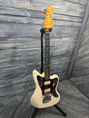 White electric guitar on a wooden floor