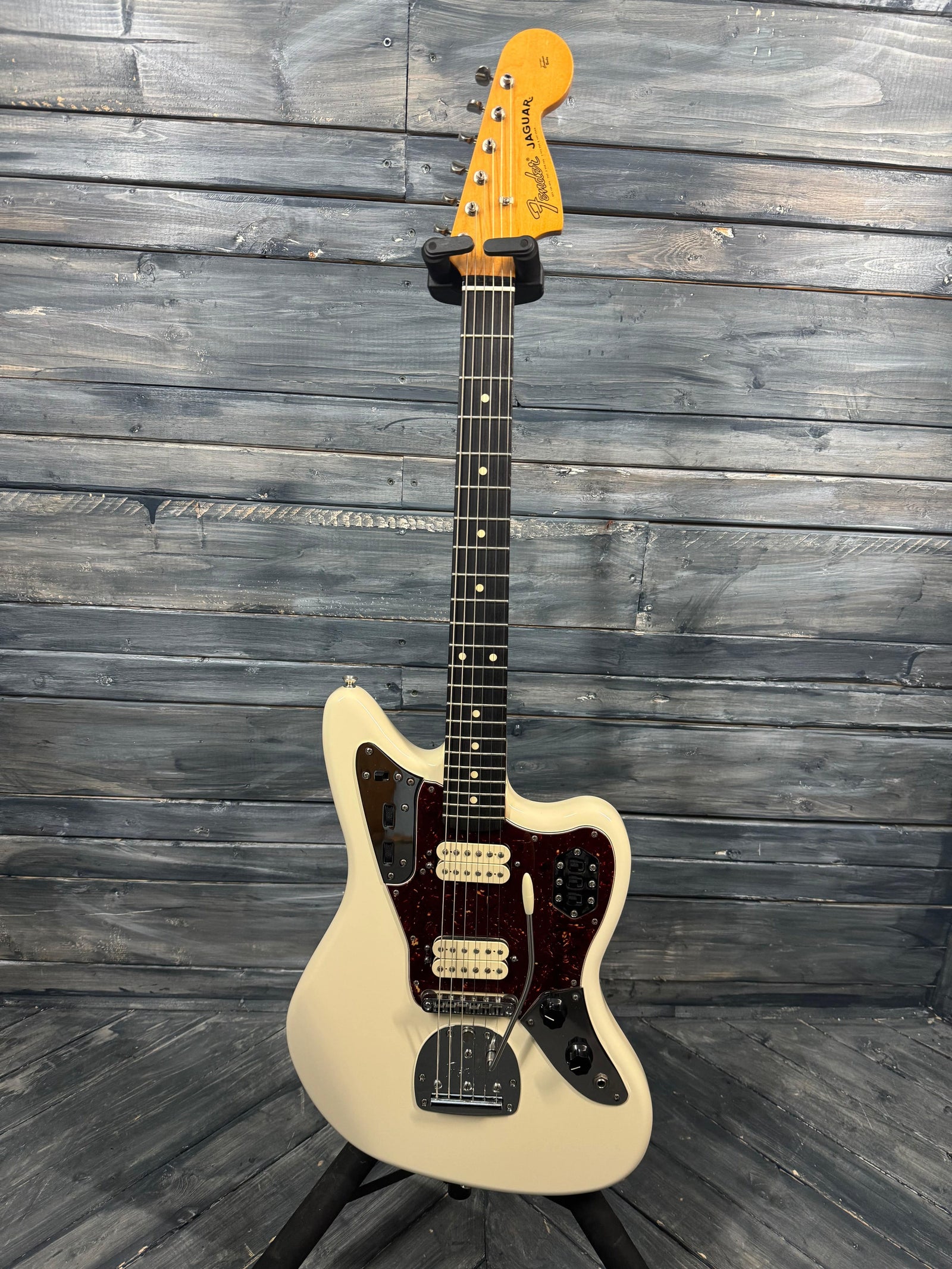 White electric guitar on a wooden background