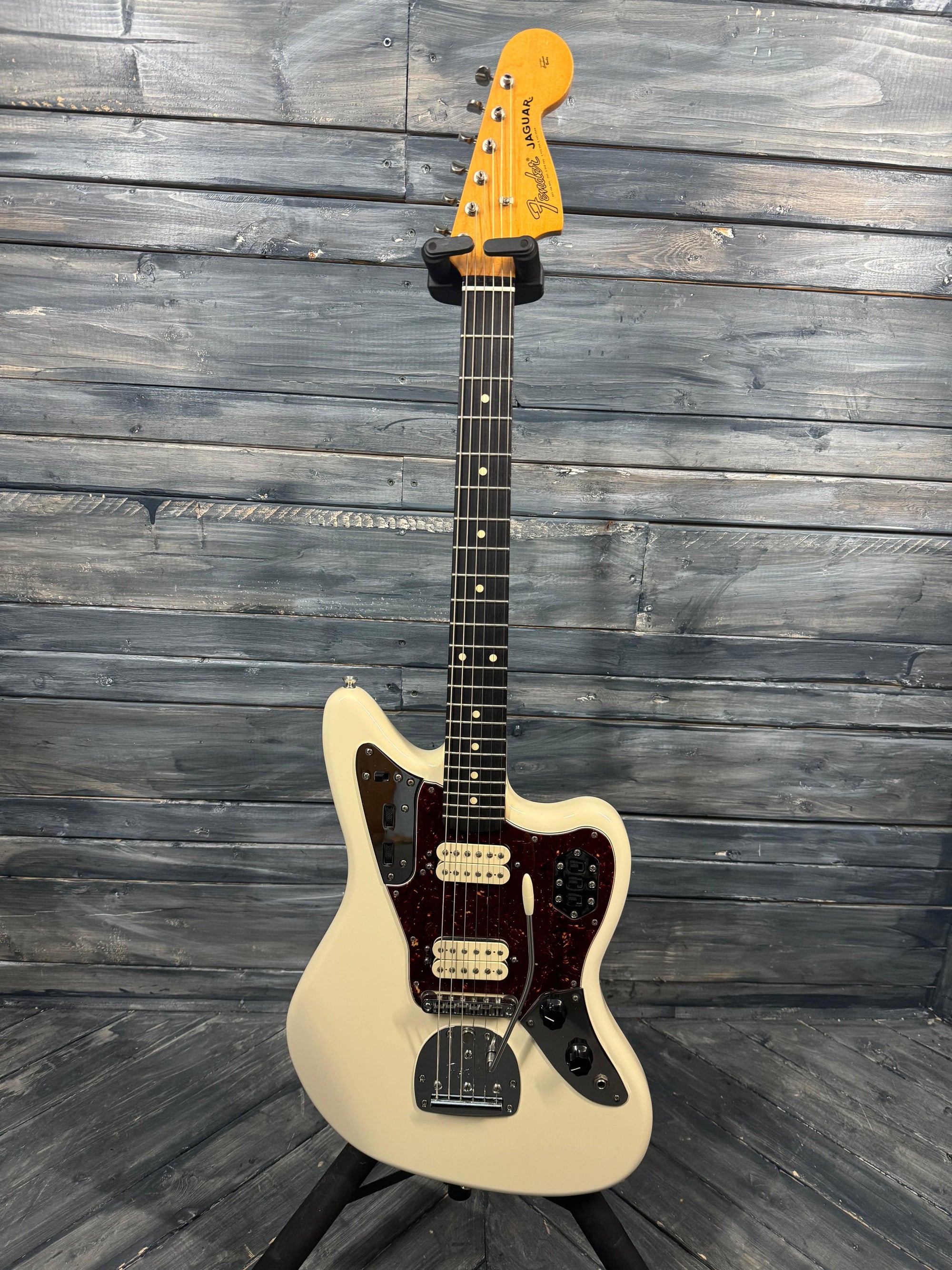 White electric guitar on a wooden background