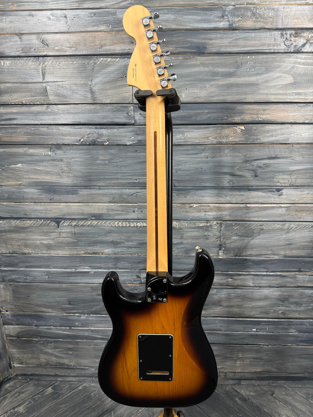 Electric guitar with a sunburst finish on a wooden background