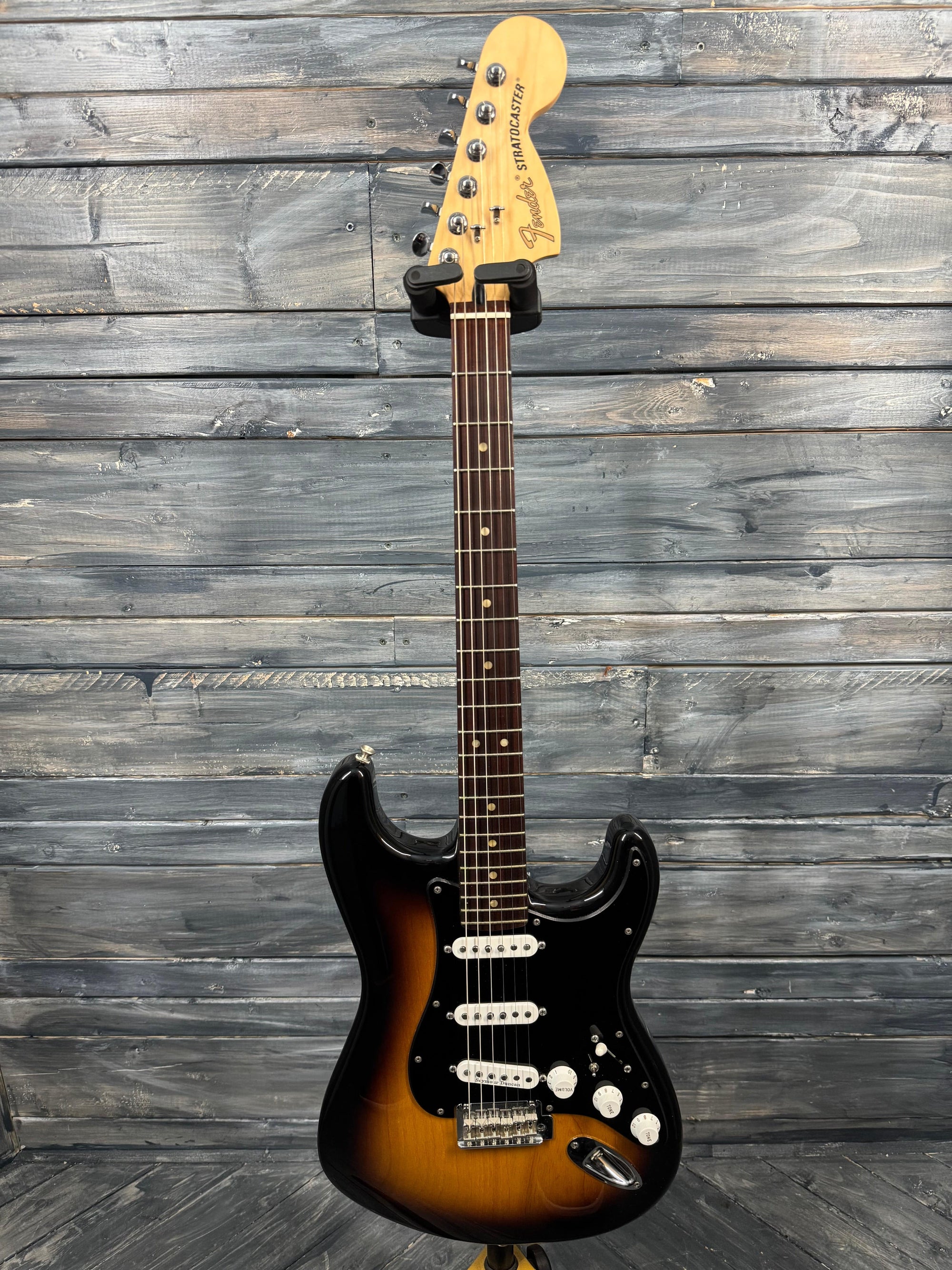 Electric guitar with a sunburst finish on a wooden background
