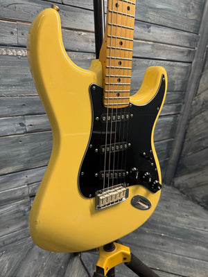 Yellow electric guitar on a wooden floor