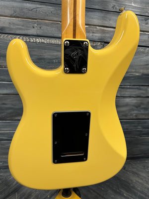 Yellow electric guitar body on a wooden surface