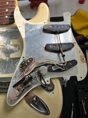 Used Fender Stratocaster back of the pickguard