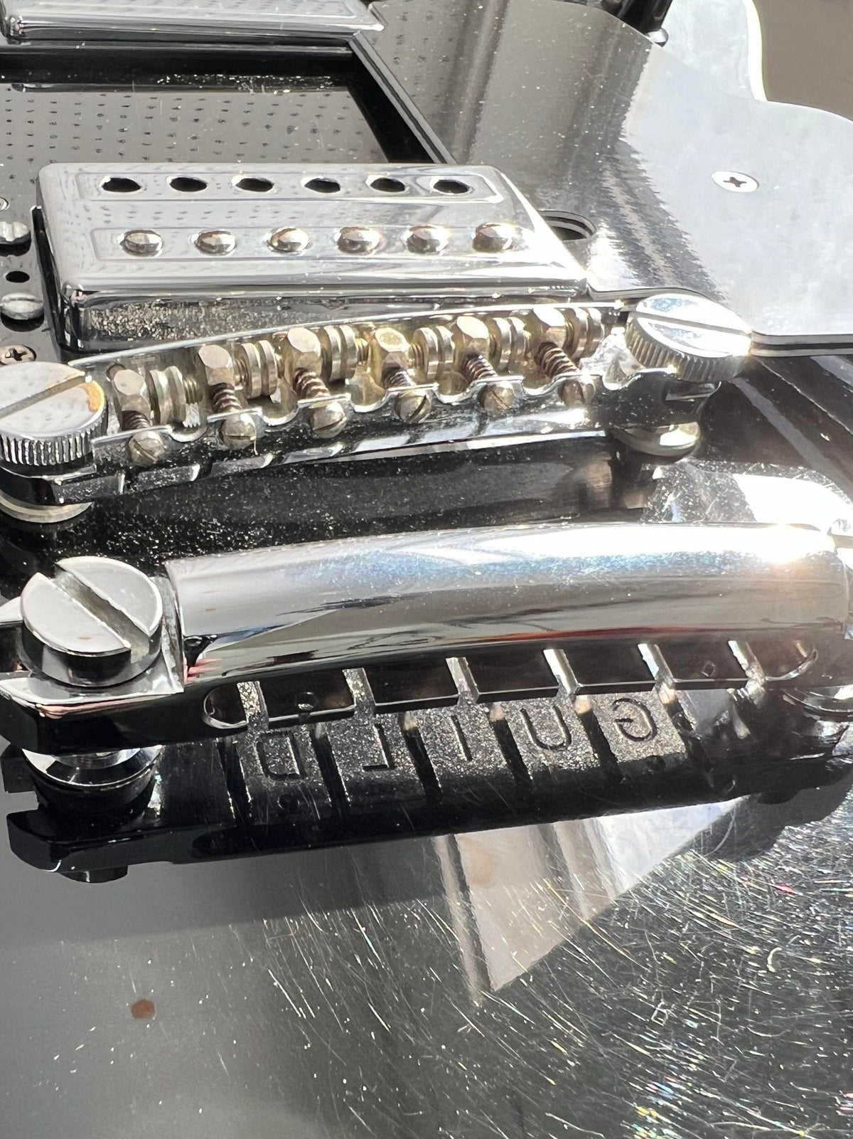 Used Guild Starfire IV close up view of the bridge and tailpiece