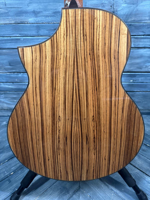 Wooden guitar body with zebrawood pattern on a wooden surface