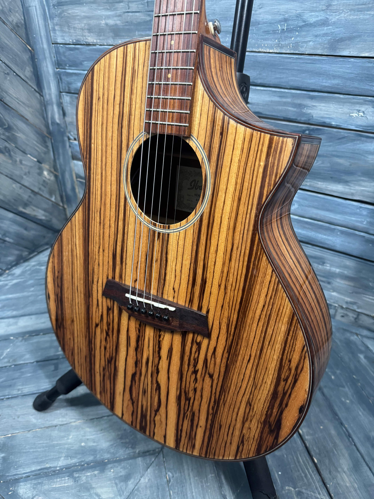 Wooden acoustic guitar on a wooden floor