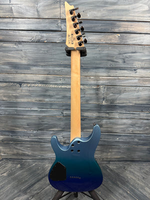 Blue electric guitar with a wooden neck against a wooden background