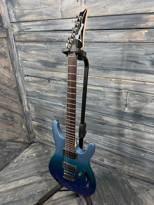 Blue electric guitar on a stand against a wooden background