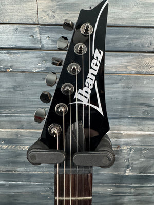 Ibanez guitar headstock on a wooden background