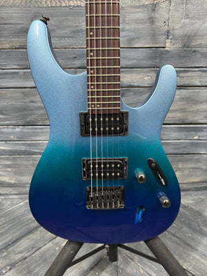 Blue electric guitar on a stand against a wooden background