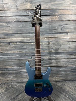Blue electric guitar on a wooden stand against a wooden wall.