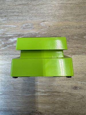 Green metal bracket on a wooden surface
