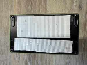 Rectangular filter with black frame and white mesh on a wooden surface