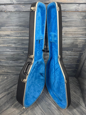 Blue guitar case with black exterior on a wooden floor