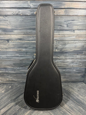 Black guitar case with a brand logo on a wooden surface