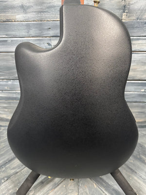 Black textured guitar body on a wooden surface