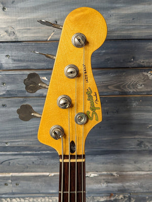 Used Squier Jazz Bass front of the headstock