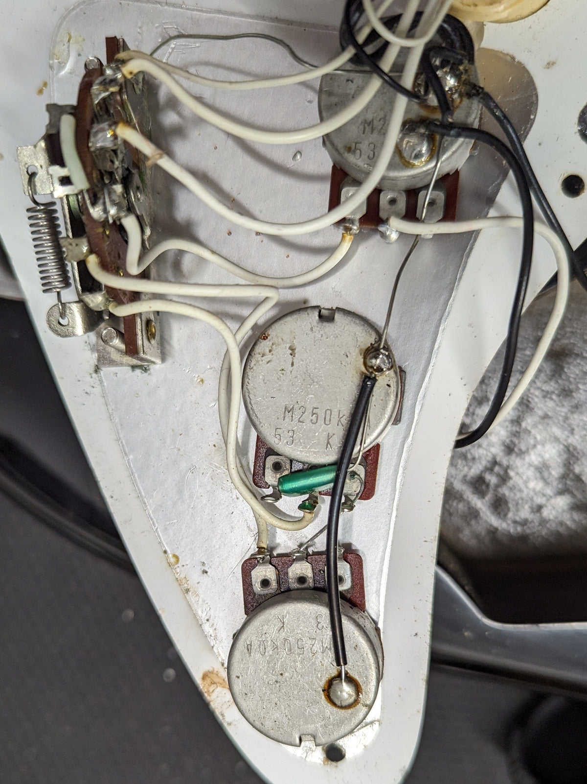 Used Squier Stratocaster close up of the pots