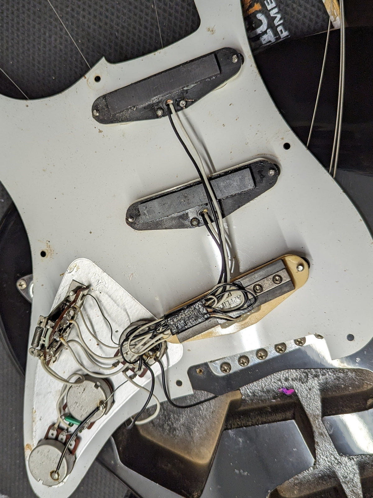 Used Squier Stratocaster back of the pickguard