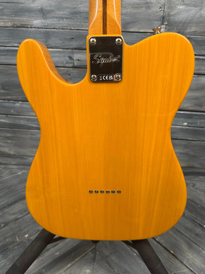 Back of a yellow electric guitar against a wooden background