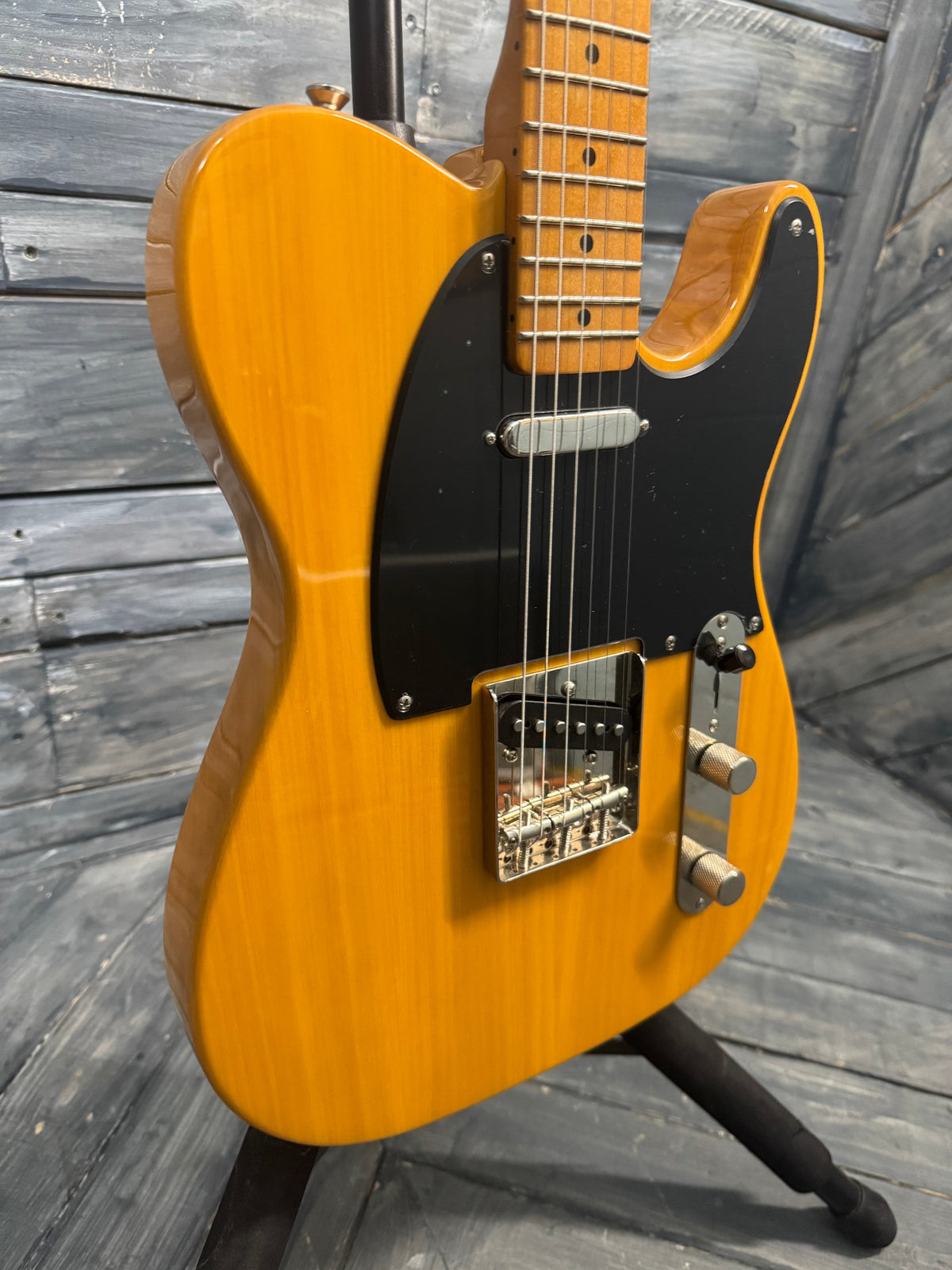 Yellow electric guitar on a wooden floor