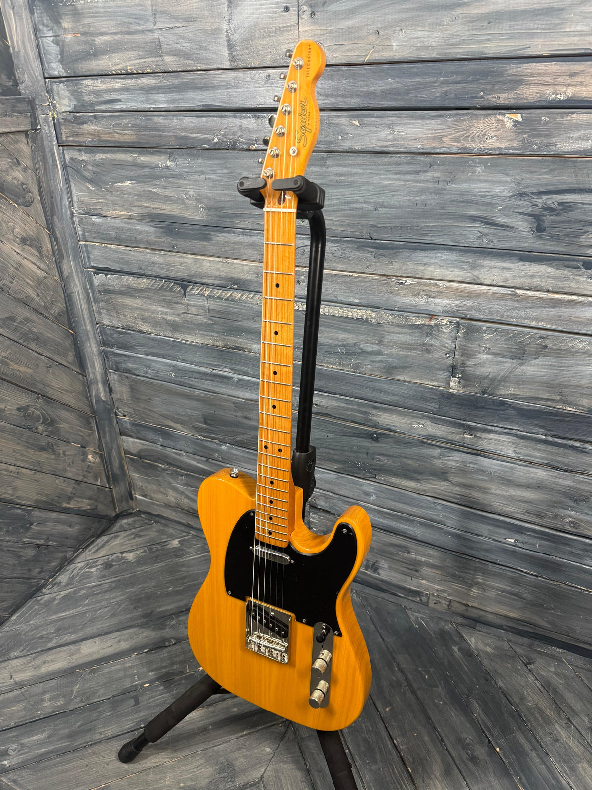 Yellow electric guitar on a wooden floor