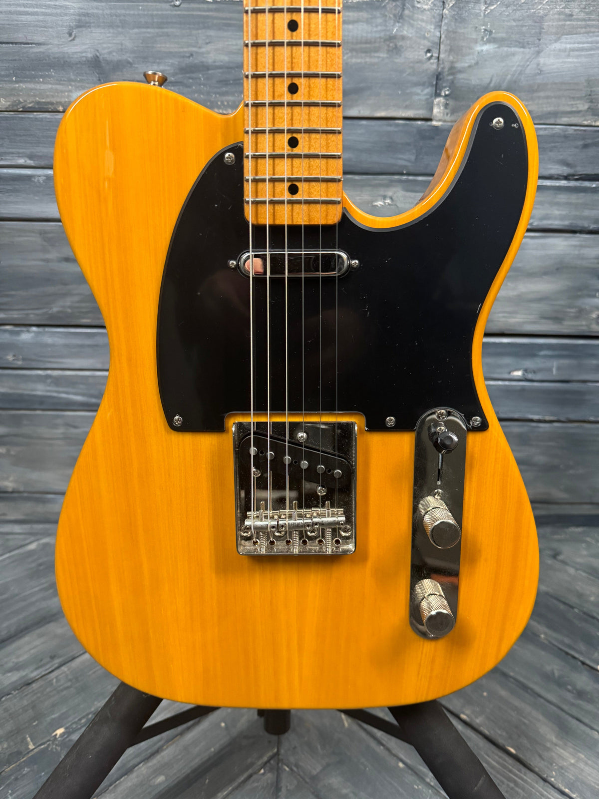 Yellow electric guitar on a wooden surface