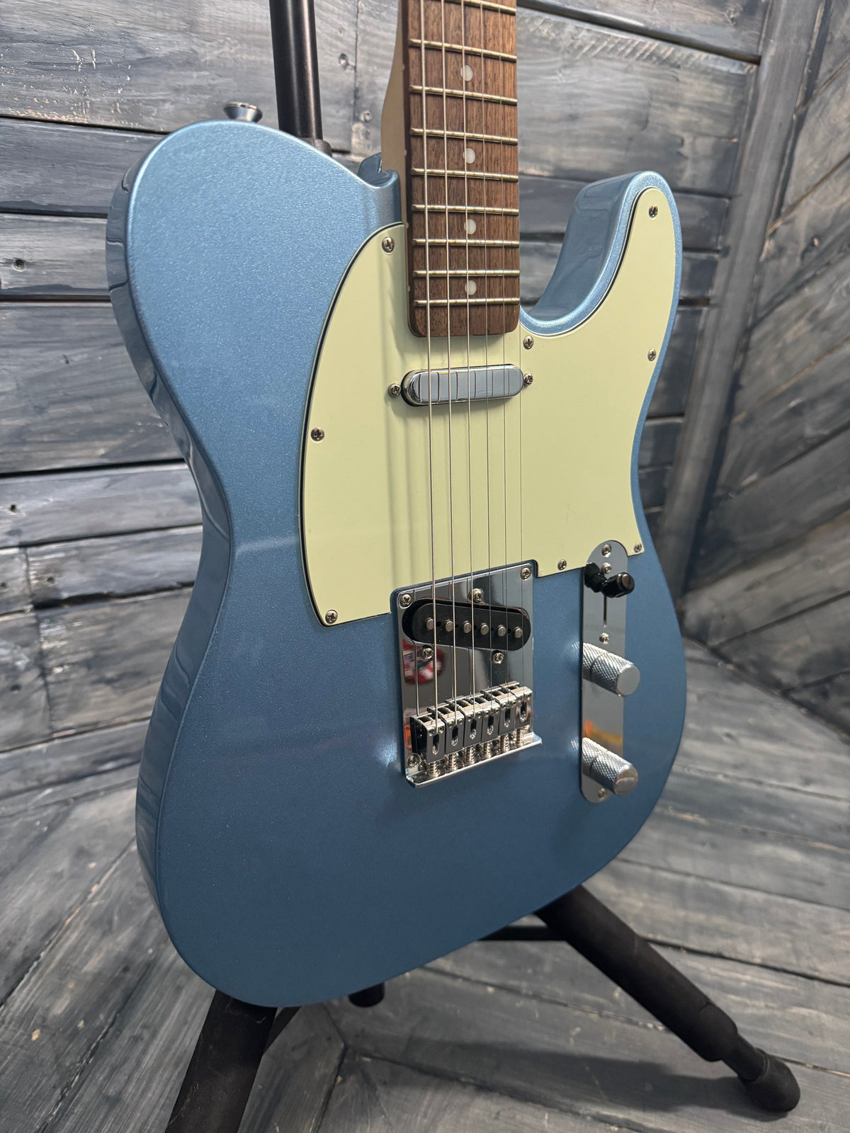 Blue electric guitar on a wooden surface