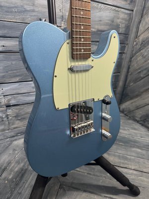 Blue electric guitar on a wooden surface