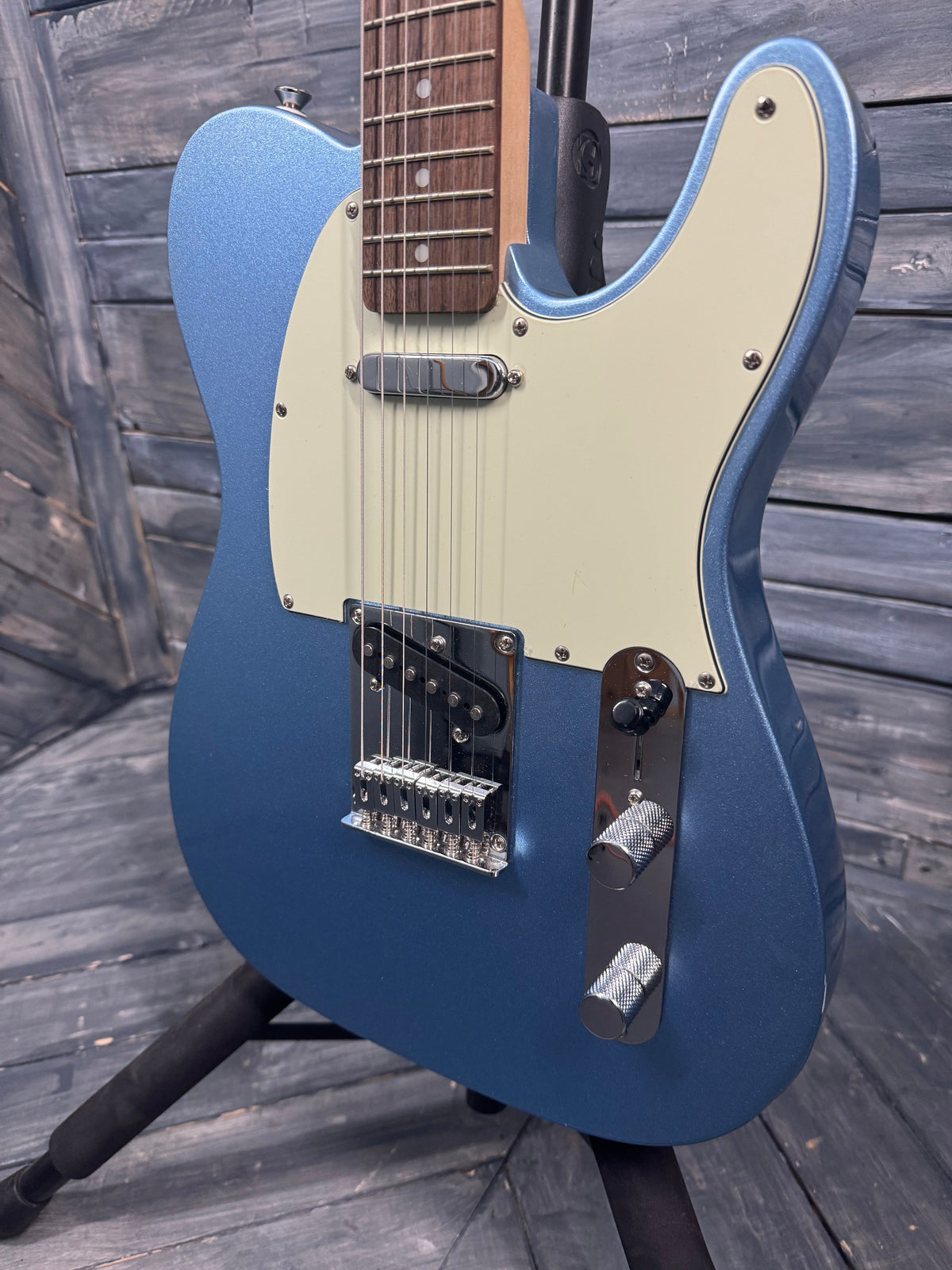 Blue electric guitar on a wooden surface
