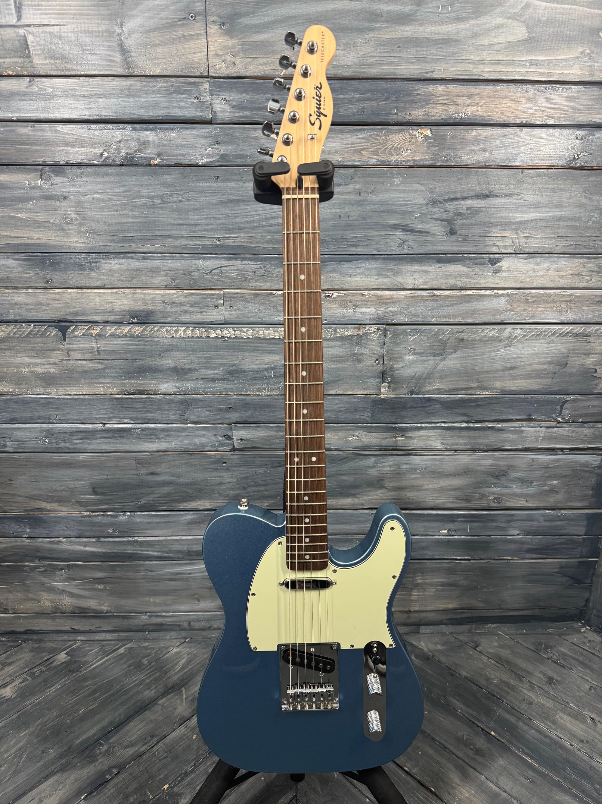 Blue electric guitar on a wooden surface