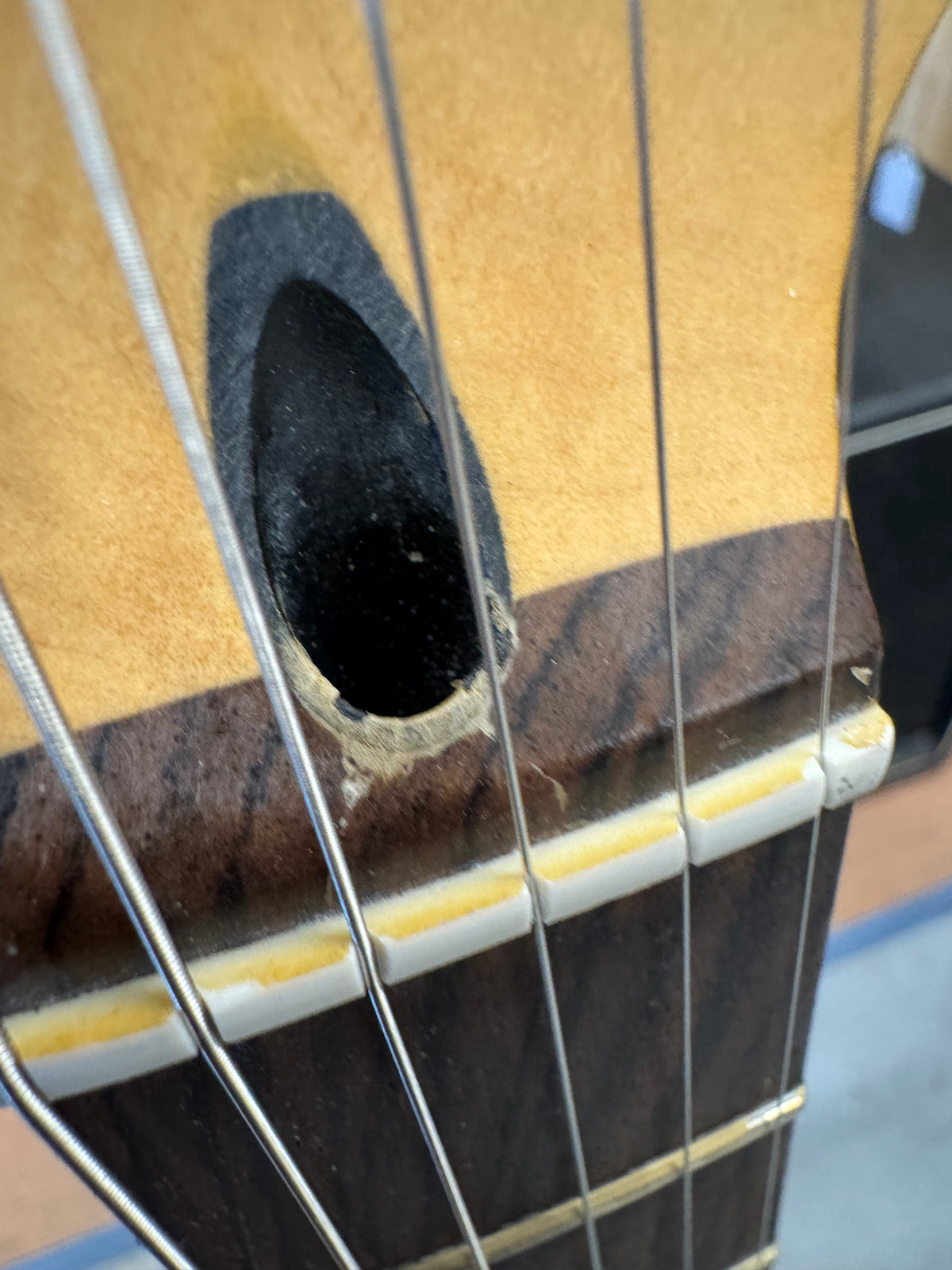 Close-up of a guitar's soundhole and strings