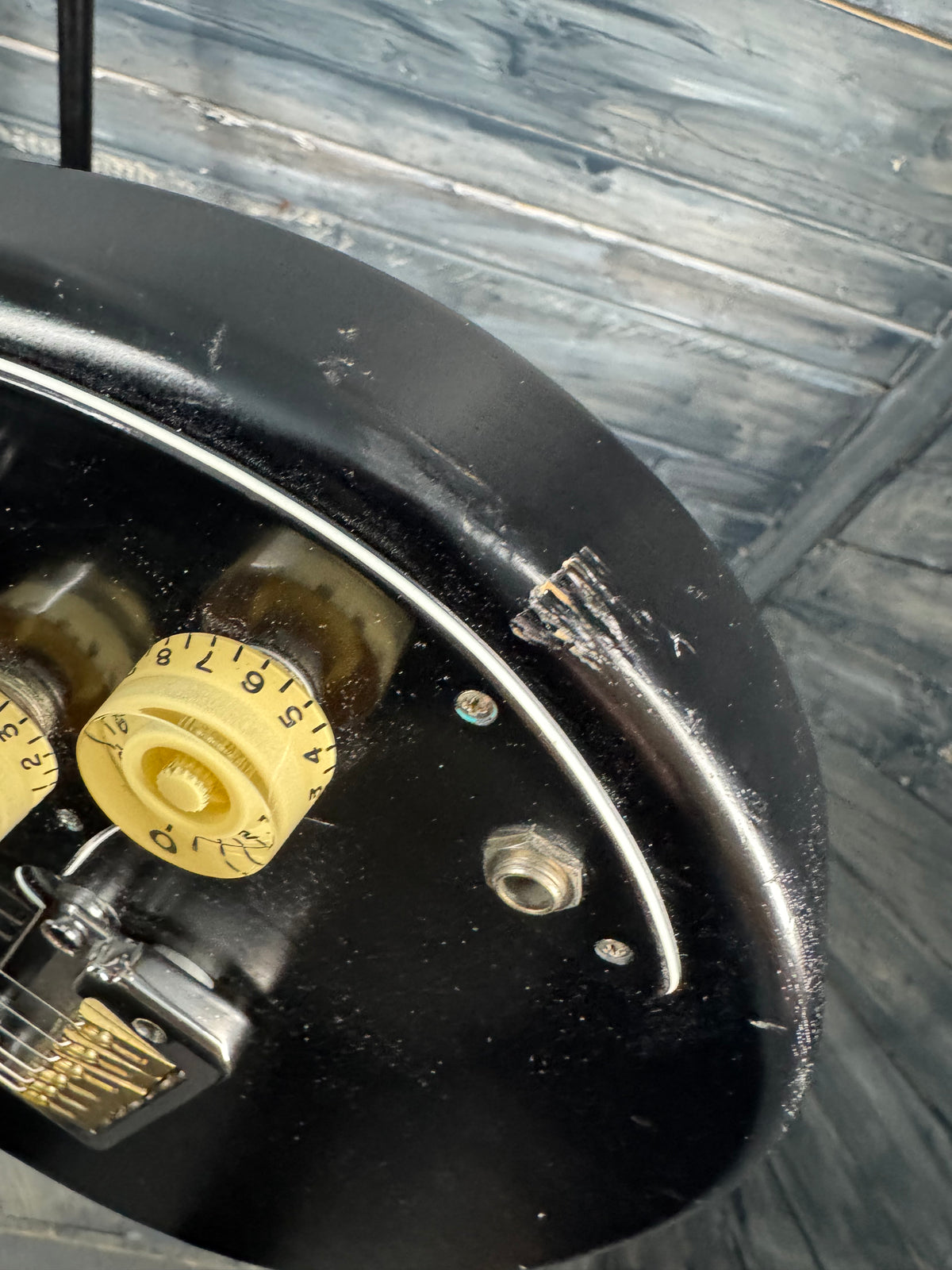 Close-up of a vintage car wheel with a yellow dial and black rim.